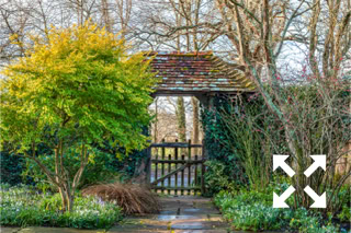 View through the lych gate at Bates Green Garden in early Spring - February